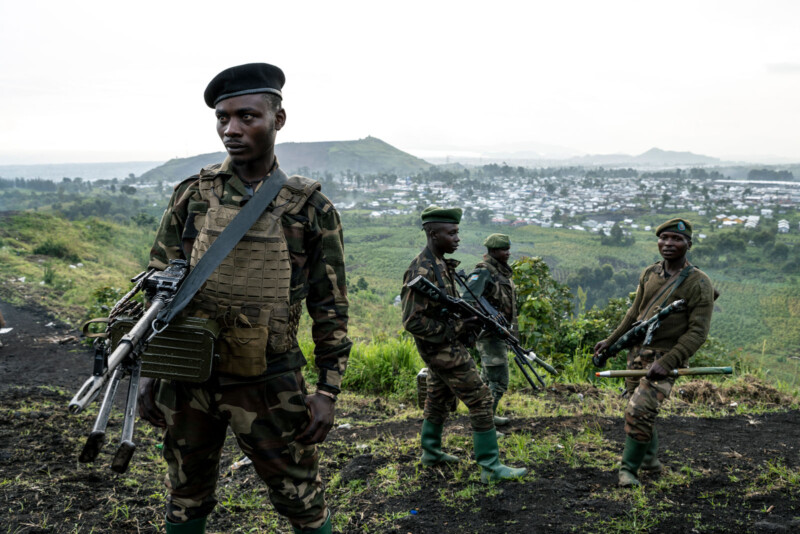 A group of men in military uniforms with guns.