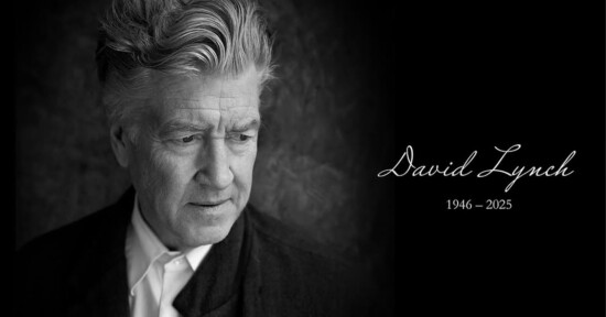 Black and white image of an older man with wavy hair looking down. He wears a suit and white shirt. Text reads "David Lynch 1946 - 2025" in cursive on the right side against a dark background.