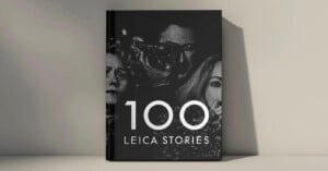 A book titled "100 Leica Stories" with a black cover featuring monochrome, partially visible images of three people, including one holding a camera, against a plain background.