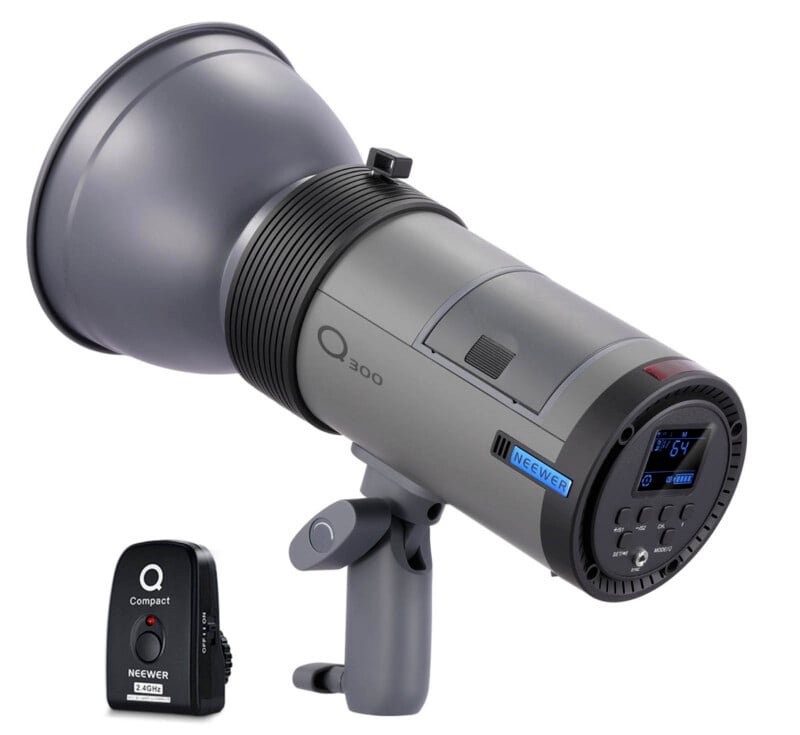 A Neewer Q300 studio strobe light sits on a mounting bracket, with a digital control panel displayed on its side. Next to it is a Neewer Q Compact wireless remote trigger.