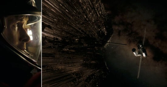 Close-up of an astronaut’s face in a helmet on the left; on the right, a spaceship approaches a large, dark, jagged structure in space with stars in the background.