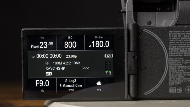 A close-up of a camera’s LCD screen displaying video settings: 23.98 FPS, ISO 800, 1/180 shutter speed, F9.0 aperture, S-Log3 color profile, XAVC HS 4K format, and 32% battery.