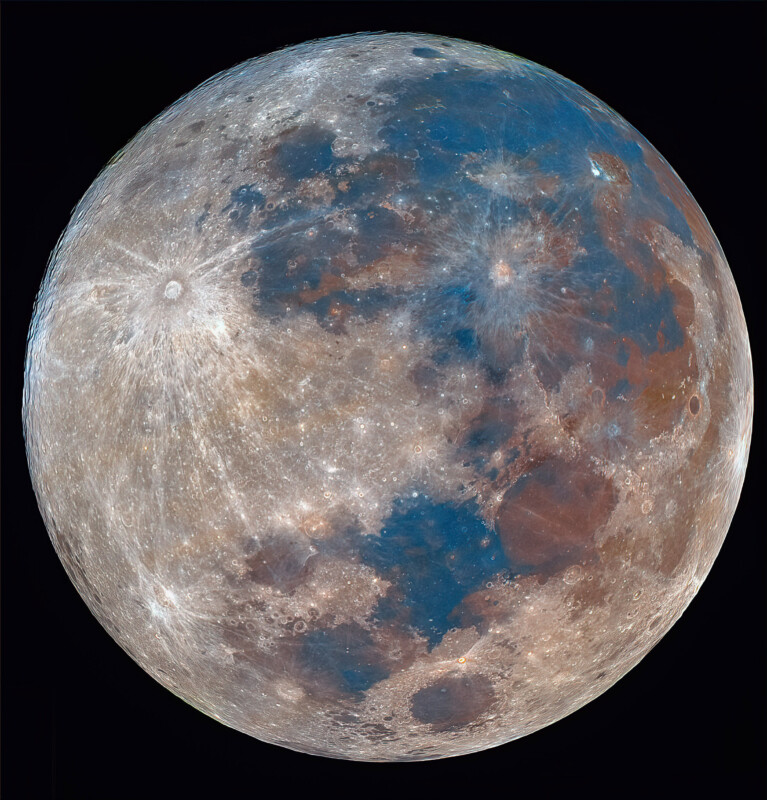 A detailed, full view of the Moon showing craters and maria in shades of gray, blue, and brown, highlighting varied surface textures and colors against a black background.